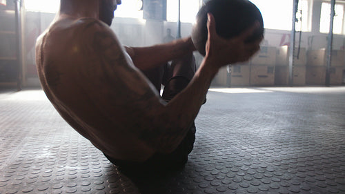 Man doing exercise with medicine ball
