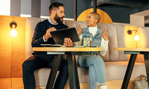 Young businesspeople having a discussion in a lobby