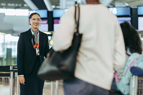Airport staff in pandemic welcoming passengers at airport
