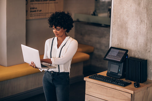 Cafe owner working on laptop