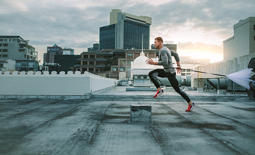 Fitness man doing workout using resistance parachute