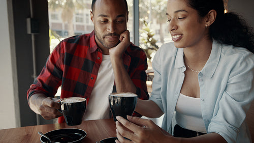 Couple enjoying a cup of coffee at cafe