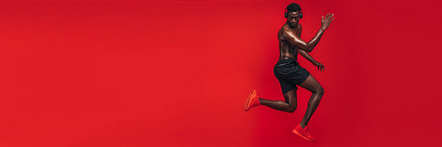 African man working out in red background
