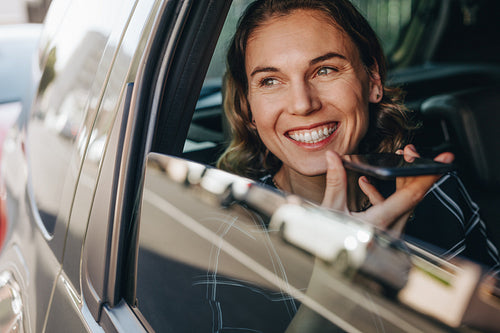Businesswoman making phone call in car