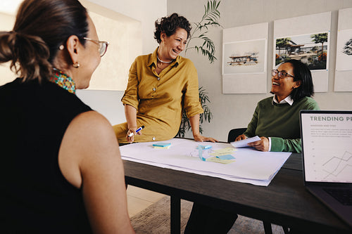 Confident female leader facilitating a planning meeting with team members