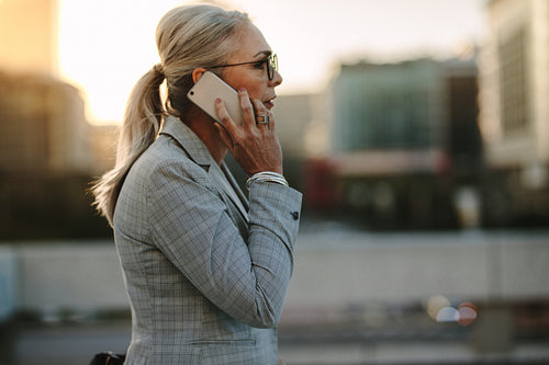 Senior businesswoman talking on cellphone in the city