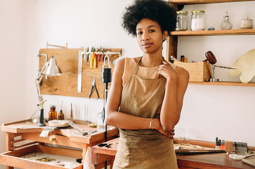 Jewelry designer artist standing in studio