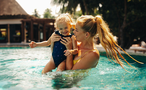 Mother and daughter enjoying holiday at tropical island resort