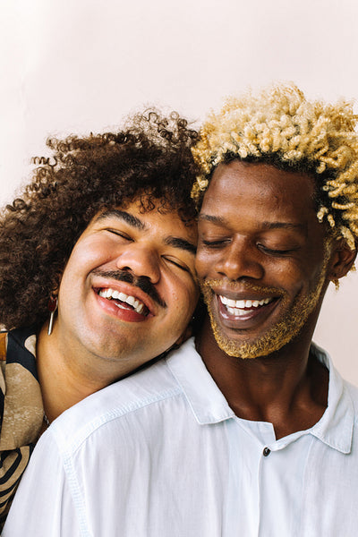 Romantic young gay man leaning on his lovers' shoulder