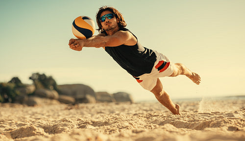 Dynamic beach volleyball player in action during championship game on coastal sand court
