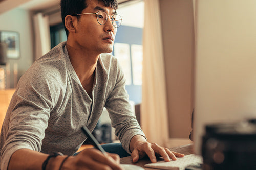 Photographer editing pictures on his computer