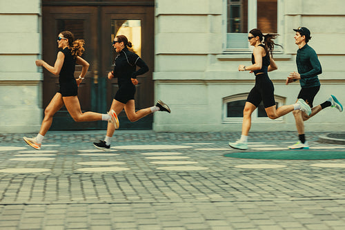 Runners running in run club: Fast motion with city background and fast-paced energy