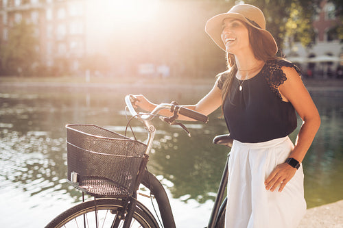 Happy woman at the park with a bicycle
