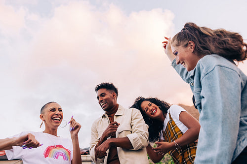 Four friends dancing on the rooftop