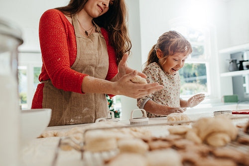 Mother and child making cookies for Christmas.