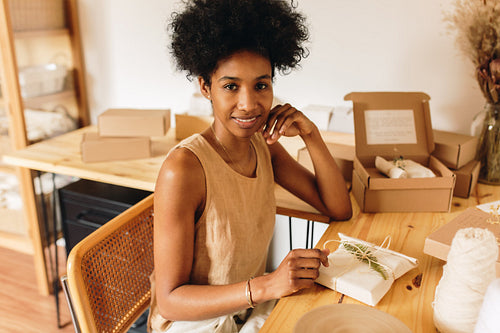 Jewelry studio owner sitting with parcel of jewelry