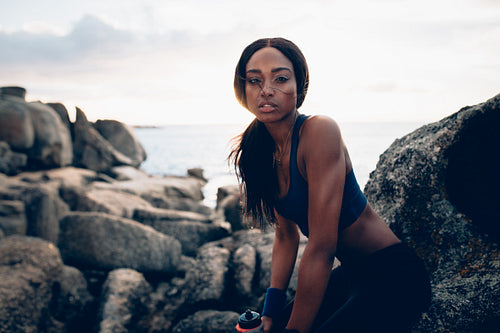 Fit african woman relaxing after workout