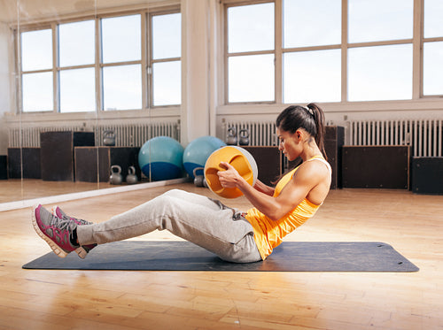 Young fitness woman exercising in gym