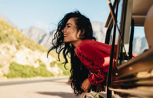 Happy woman enjoying road trip