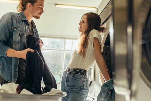 Couple in love standing together in a laundry room
