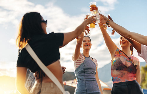 Raising a toast to summer: Friends celebrating a festival with cold beers