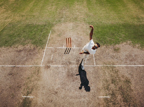 Aerial view of a cricketer bowling on a cricket pitch