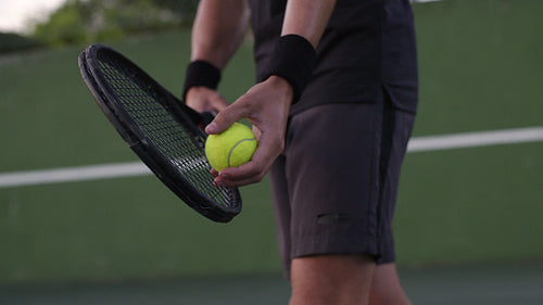 Tennis player focusing on his serve