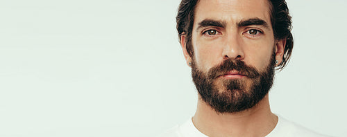 Portrait of a young man with glowing and healthy skin in a studio