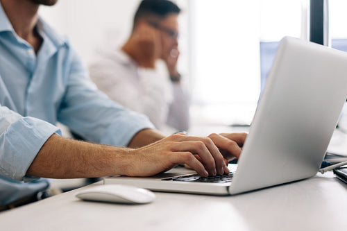 Application developers working on computers in office