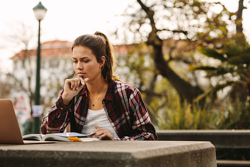 Female student preparing notes for exams