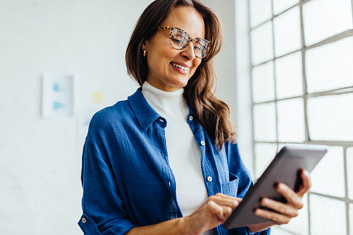 Happy female professional using a digital tablet at work