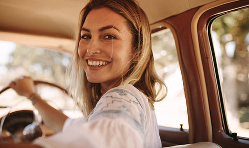 Beautiful female driving a old car