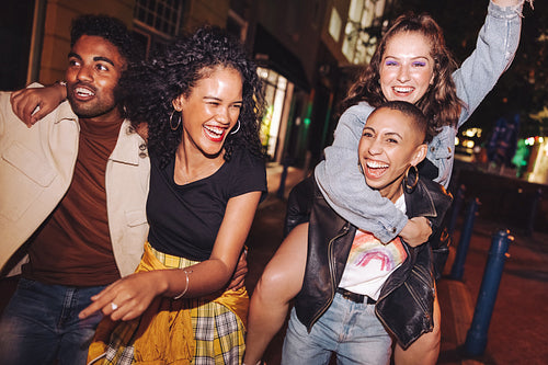 Young people laughing and living their best lives in the city