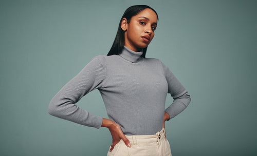 Stylish young woman looking at the camera in a studio