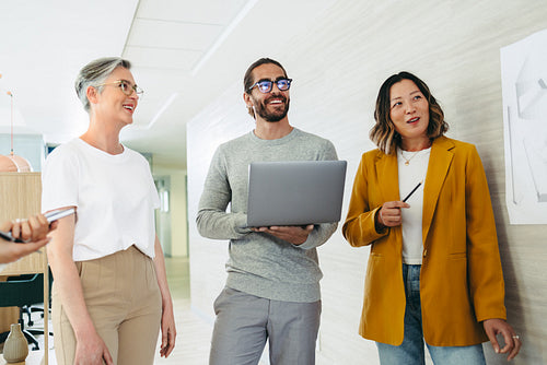 Happy designers smiling cheerfully in a creative office