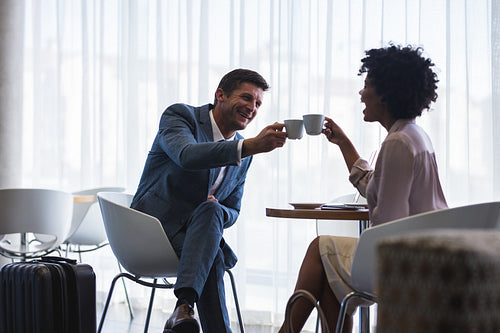 Business partners having coffee at airport cafeteria