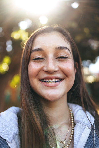 Adorable teenage girl with braces smiling cheerfully