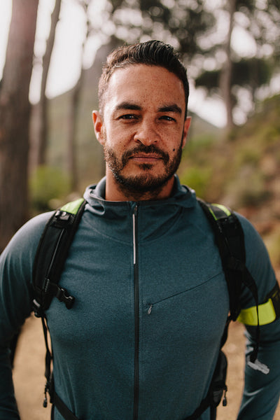 Portrait of young male athlete standing outdoors