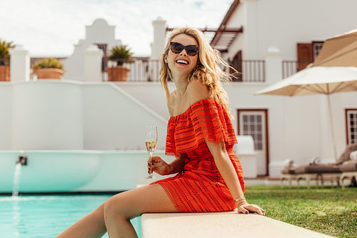 Beautiful woman relaxing by the pool