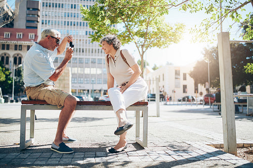 Senior couple on vacation taking pictures