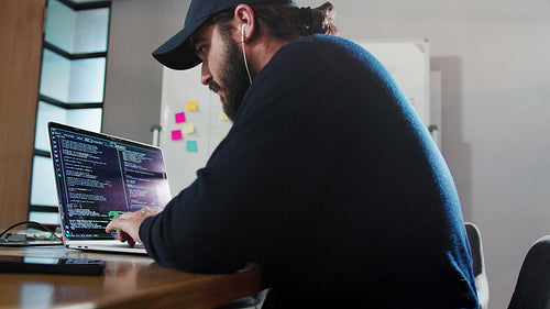 Computer programmer working on a code in an office