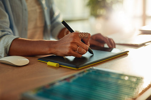 Female designer using a graphic tablet and stylus pen