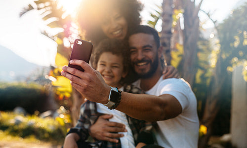 Happy family on a vacation taking a selfie on mobile phone