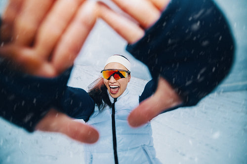 Female athlete portrait captures winter training with playful energy in the snow