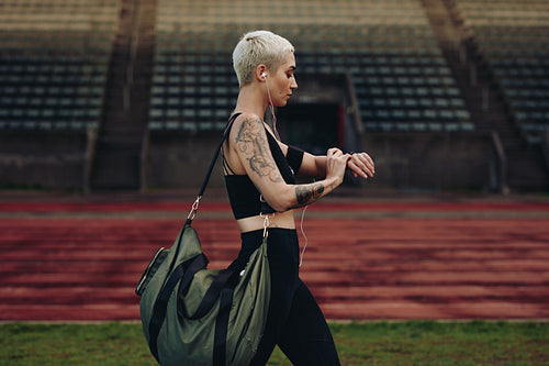 Woman runner walking inside an athletic ground