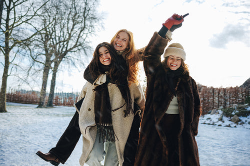 Friendship shines as women share a piggyback ride in snow