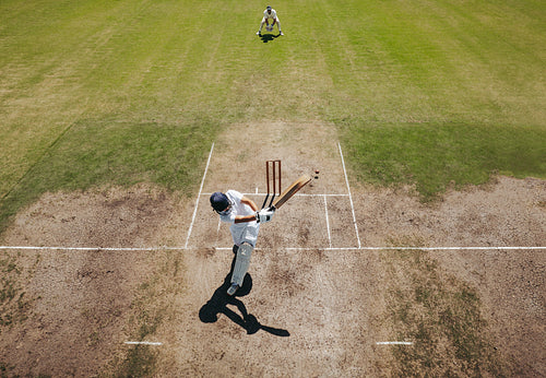 Cricket batsman in action during a game on a sunny day