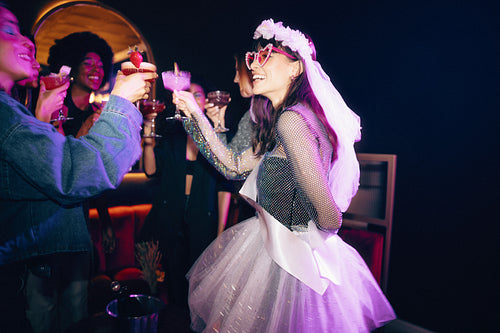 Group of friends celebrating with drinks at a festive party event