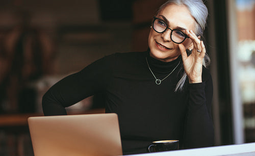 Senior businesswoman thinking at cafe