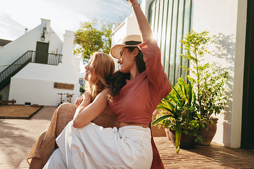 Best friends dancing while on a vacation